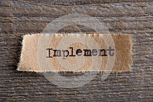 Implement - word on a piece of paper close up, business creative motivation concept