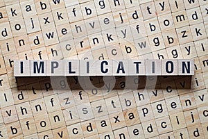 Implication word concept on cubes photo
