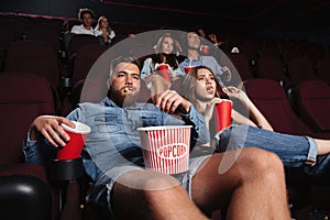 Impolite rude couple sitting in a cinema