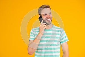 Importance of being communicative. Happy man talk on mobile phone yellow background. Verbal communication. Mobile