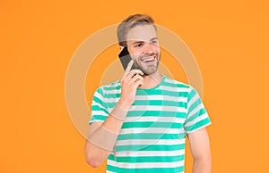Importance of being communicative. Happy man talk on mobile phone yellow background. Verbal communication. Mobile