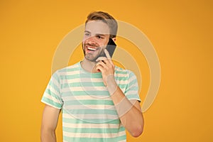 Importance of being communicative. Happy man talk on mobile phone yellow background. Verbal communication. Mobile