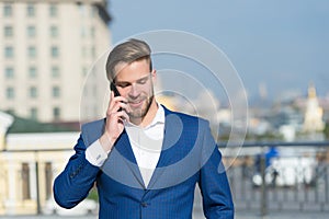 Important business call. Businessman happy smiling use smartphone for business communication, skyline background. Man