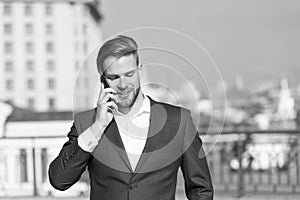 Important business call. Businessman happy smiling use smartphone for business communication, skyline background. Man