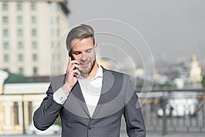 Important business call. Businessman happy smiling use smartphone for business communication, skyline background. Man