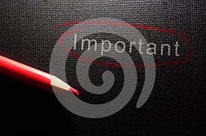 Important text circled in red pencil on black textured paper background