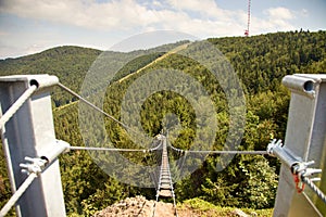 Rope bridge over the ravine under the hill Skalka with transmitter tower, Slovakia
