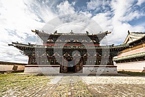 An imposing building of a traditional Mongolian monastery in the steppe of central Mongolia.