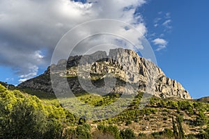 imposing mountain Puig Campana with a blue cloudy sky photo