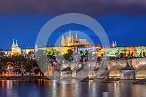 The imposing St. Vitus Cathedral and the Charles Bridge at night