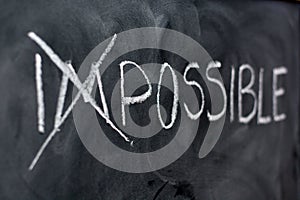 Impossible handwritten on blackboard photo