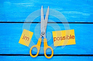 Impossible Is Possible Concept. card with the text impossible, scissors cut a word to them. success and challenge concept. I can,