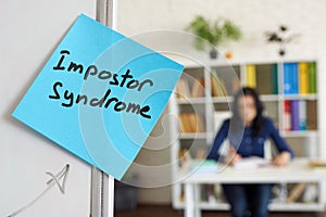 Impostor syndrome written on the sticker on the whiteboard. photo