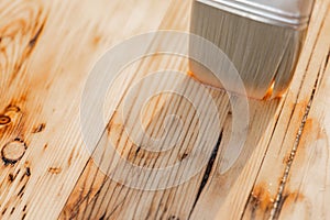 Impregnation of wooden boards with oil.Protecting the wooden surface from damage.Impregnation of a table with protective