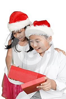 Impressed children open christmas presents photo