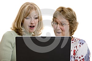 Impressed women looking at computer screen