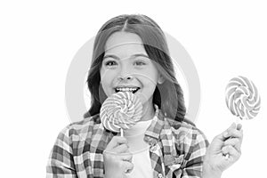 Impressing fact sugar nutrition. Girl child smiling holds lollipop candy. Girl kid with lollipop looks happy. Healthy photo
