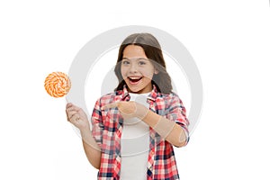 Impressing fact sugar nutrition. Girl child smiling holds lollipop candy. Girl kid with lollipop looks surprised