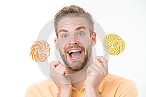 Impressing fact sugar nutrition. Man handsome bearded guy holds lollipop candy. Man with lollipop looks surprised photo