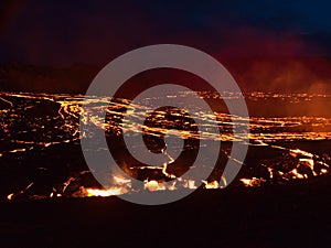 Glowing lava flow at volcanic eruption site in Geldingadalir valley near Fagradalsfjall mountain, Reykjanes, Iceland. photo