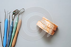 Impression of the patient's jaw and dental instruments on a blue background. Dental clinic concept. The concept of bite