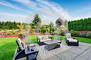 Impressive backyard landscape design with patio area photo