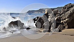 Impressive cliffs at Cape Espichel on coast of Atlantic Ocean in Portugal under blue sky