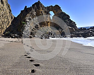 Impressive cliffs at Cape Espichel on coast of Atlantic Ocean in Portugal under blue sky