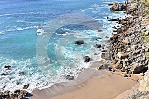 Impressive cliffs at Cape Espichel on coast of Atlantic Ocean in Portugal under blue sky