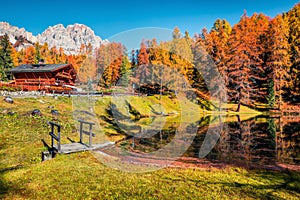 Impressive colors view of Scin lake with yellow larch trees. Colorful sunny scene of Dolomite Alps, Cortina d`Ampezzo location,