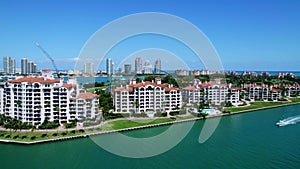 Impressive drone view of Fisher Island displaying grand residential complexes along beachfront of Atlantic ocean