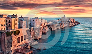 Impressive evening cityscape of Vieste - coastal town in Gargano National Park, Italy, Europe. Fantastic summer sunset on Adriatic