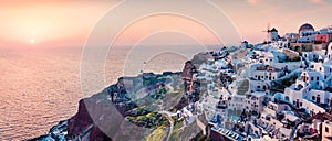 Impressive evening panorama of Santorini island. Picturesque spring sunset on the famous Greek resort Oia, Greece, Europe.