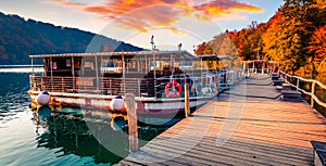 Impressive evening view of pure water lake with boats in Plitvice National Park. Captivating autumn sunset of Croatia, Europe. Bea