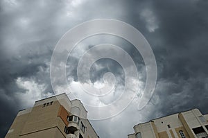 Impressive gray clouds above buildings