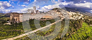 Impressive medieval Assisi town in Umbria over sunset. Italy. aerial drone panoramic view.