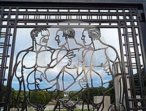 Impressive men figures on wrought iron gate with the Frogner Park in the background, Oslo, Norway