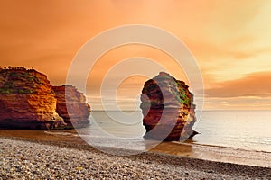 Impressive red sandstones of the Ladram bay on the Jurassic coast, a World Heritage Site on the English Channel coast of southern