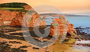 Impressive red sandstones of the Ladram bay on the Jurassic coast, a World Heritage Site on the English Channel coast of southern