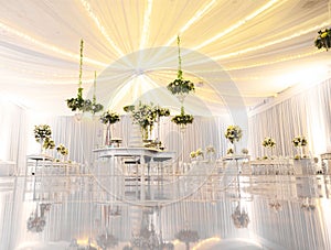 IMPRESSIVE SILVER RECEPTION VENUE WITH BEAUTIFUL WHITE  WEDDING CAKE AT CANDY TABLES, FLORAL GREEN DECORATION, REFLECTIVE FLOOR, B