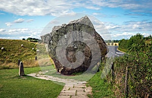 Impressive standing stones from the historic circle in Avebury Wiltshire. Sheep can be seen grazing amongst the massive rocks