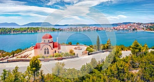 Impressive summer cityscape of Ermioni port and Greek Orthodox church St. Gerasimos on foreground.