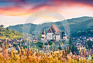 Impressive summer sunrise on Fortified Church of Biertan,