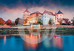 Impressive sunrise view of Hartenfels castle. Splendid morning view of Torgau town on the banks of the Elbe in northwestern Saxony