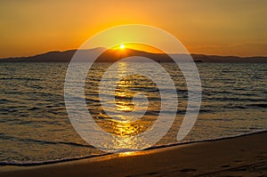 An impressive sunset on the beach in Naxos island.