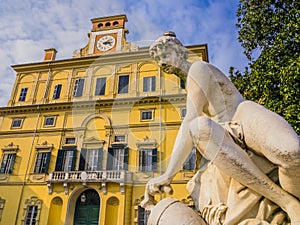 Ducal garden`s palace with close-up of marble statue, Parma, Italy photo