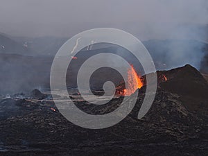 Impressive view of erupting volcano in Geldingadalir valley near Fagradalsfjall mountain, Reykjanes southwest Iceland with smoke.