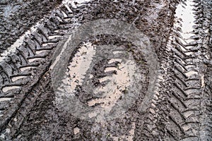 Imprint of an off-road vehicle tire on a dirty road