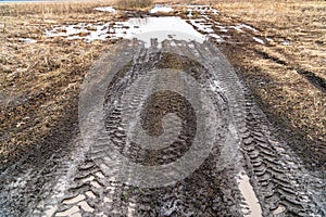 Imprint of an off-road vehicle tire on a dirty road