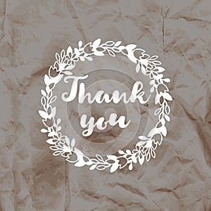 Imprint of the stamp Thank you on a crumpled kraft paper background.